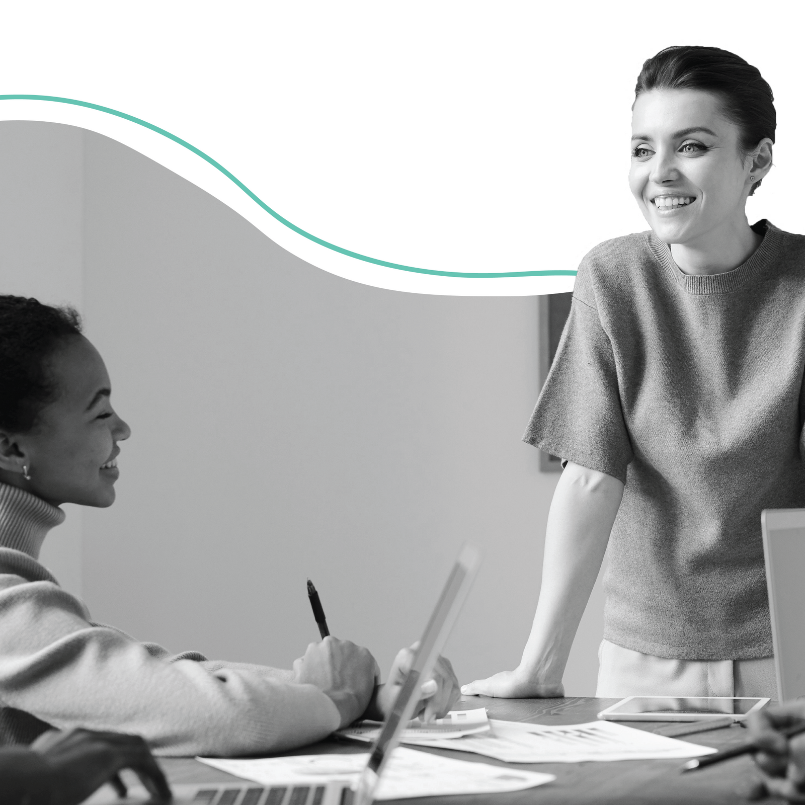 two women working together at a desk