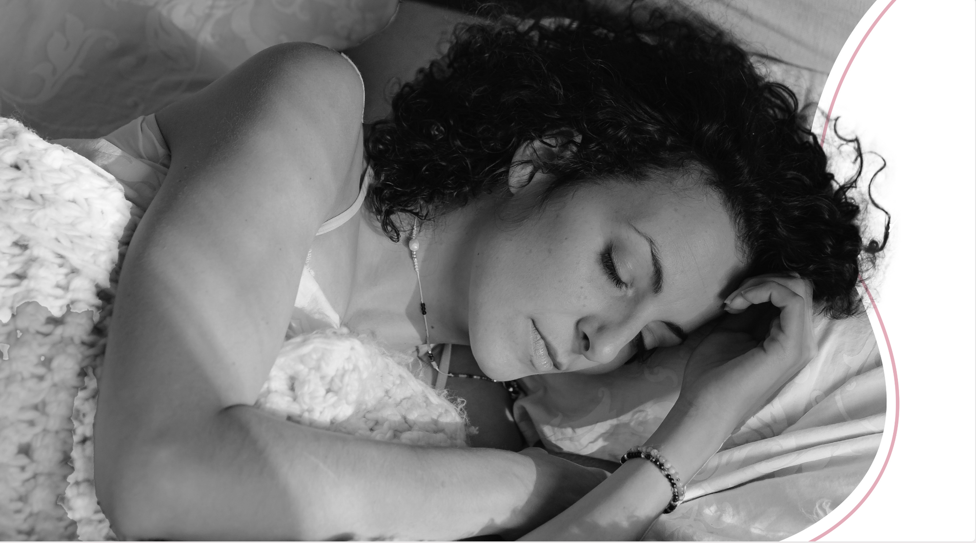 woman with dark hair sleeping, in black and white